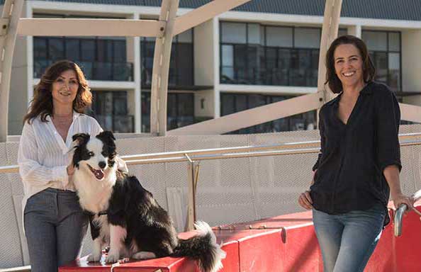 Ayda, Tracey and Archie from PetWell standing on a bridge outdoors